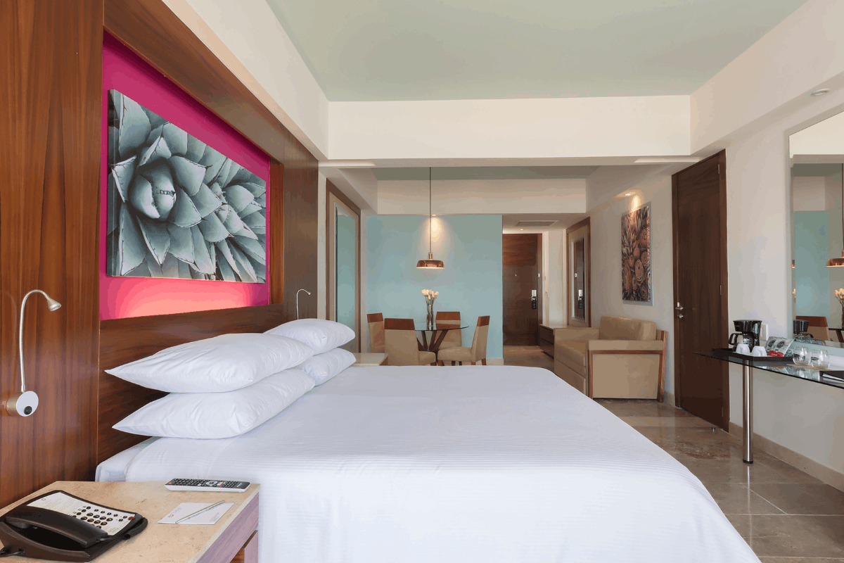Junior Suite ocean view at Krystal Grand Los Cabos with king bed, balcony, living area and Sea of Cortes view.